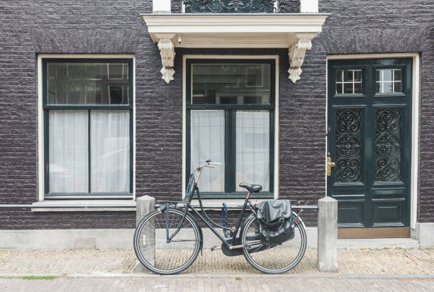 istock Typical Amsterdam street view in Netherlands with old doors and windows and vintage bicycle 1125373371