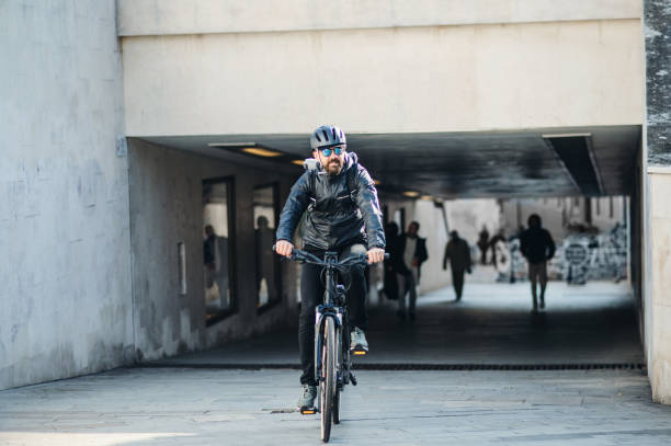 istock Male bicycle courier delivering packages in city. Copy space. 1125374644