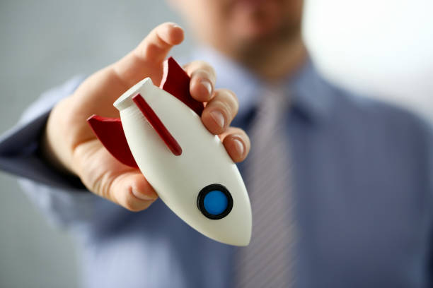 istock Businessman in suit hold white rockrt in hand 1125376811