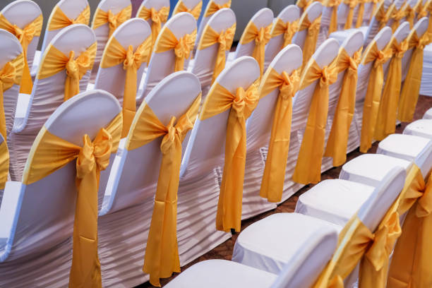 The back of yellow and gold wedding chairs stock photo