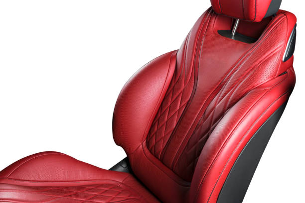 istock Red leather interior of a car. Perforated red leather comfortable seats with stitching isolated on white background. car interior details. Car detailing. Car inside 1125381982