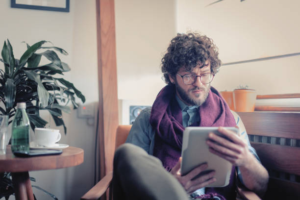 istock Man sitting in the coffee shop and using tablet 1125383074