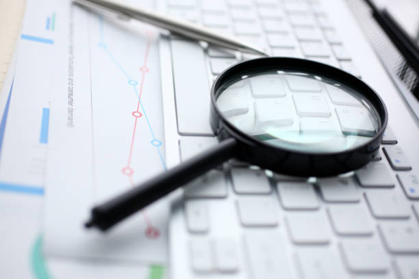 istock Magnifying glass lies on white keyboard on 1125384974