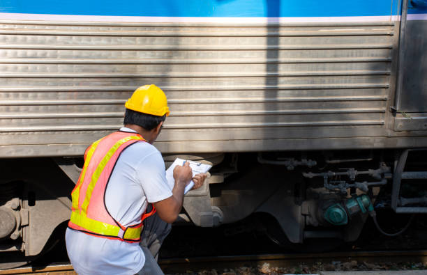 istock Asian engineer wearing safety helmet with checking train for maintenance in station 1125387750