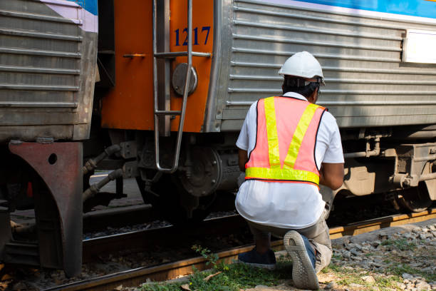 istock Asian engineer wearing safety helmet with checking train for maintenance in station 1125387762