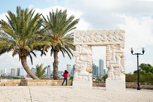 Tel Aviv, Old Yafo, Israel - December 23, 2018: A tourist enjoying view of Tel Aviv from the hill  in Abrasha Park, Old City of Yafo