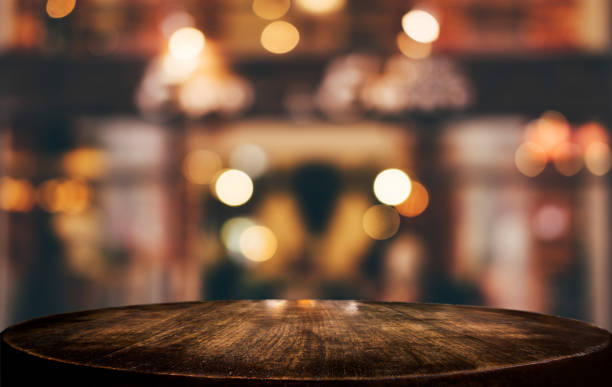 istock Selective Empty wooden table in front of abstract blurred festive light background with light spots and bokeh for product montage display of product 1125391416