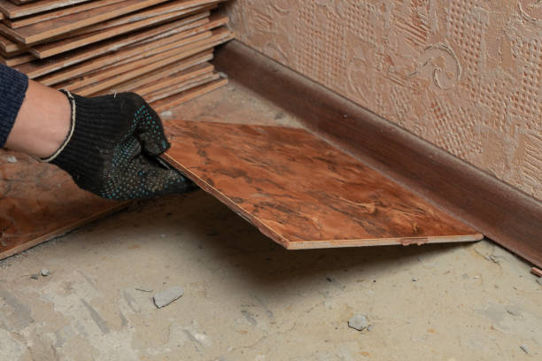 istock Floor tiles installation. A man installs ceramic tile, renovation in progress 1125396115