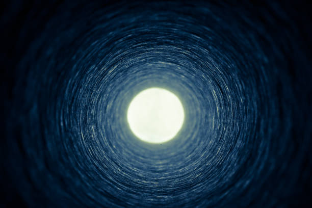 istock Looking down a cardboard tube towards a bright source of light 1125397105