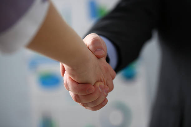 istock Man in suit and tie give hand as hello in office 1125399000