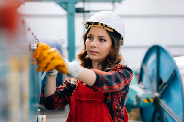 istock Female worker handling machine in factory 1125401485