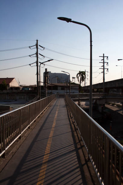 istock Bridge road with power lines, antennas and building rooftops 1125403849