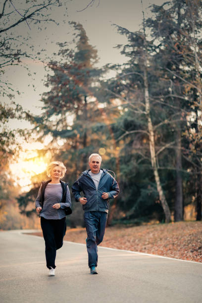 istock Senior couple jogging in a forest 1125404004