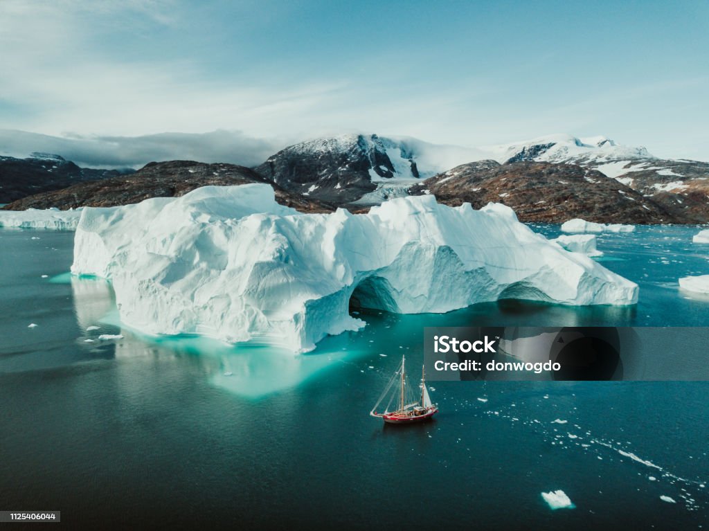 Sailing Expedition in East Greenland Photo from an expedition with a sailing boat through the beautiful vast landscape of huge icebergs and impressive mountainscapes in East Greenland. Greenland Stock Photo