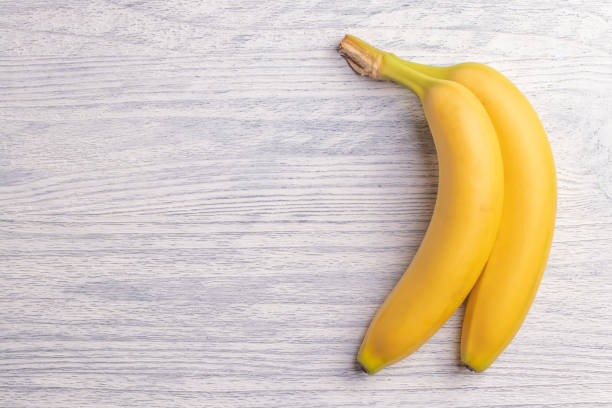 istock Sweet bananas on white wooden table 1125411699