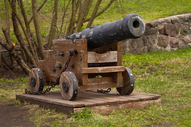 istock the old cast-iron cannon on a wooden stand 1125413677