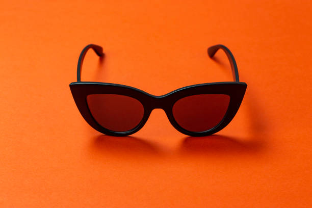 istock Women's retro sunglasses cat or fox on a bright orange background. 1125415593