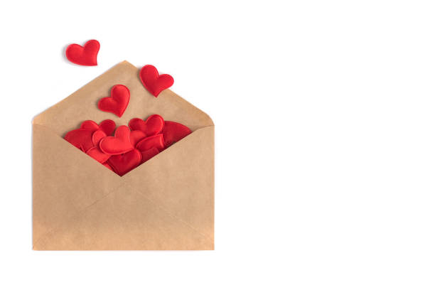 istock Red small hearts in a craft envelope on a white isolation background. St. Valentine’s Day card 1125416311
