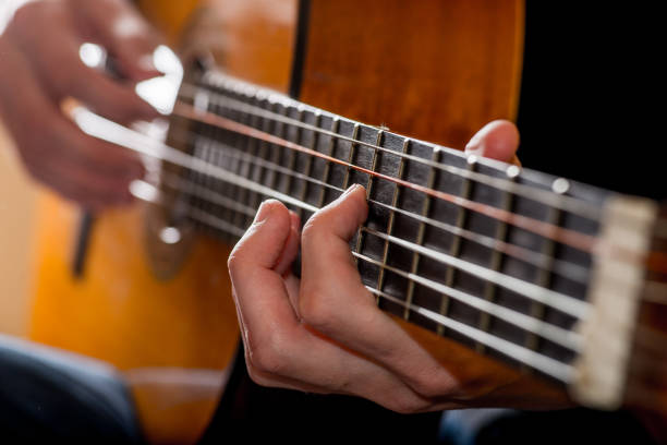 istock adult white guy playing an acoustic guitar. Backlit shooting 1125417839