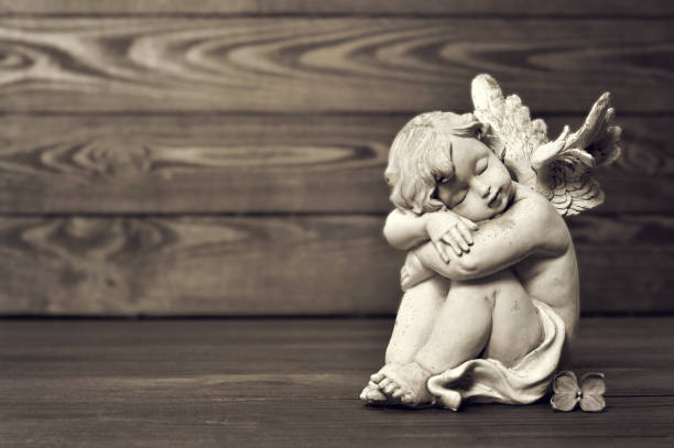 istock Angel sleeping on wooden background 1125419860