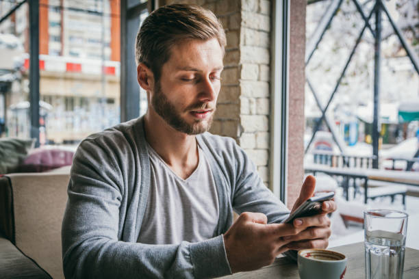 istock Man in cafe - The man in the cafe is using the phone 1125421191