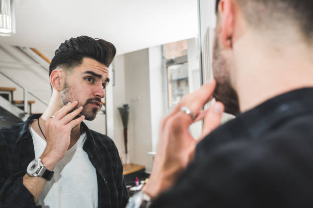 istock Handsome man in front of mirror looking himself 1125422993