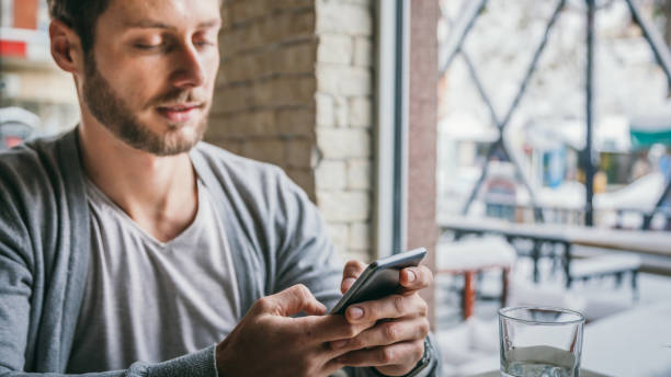istock Man in cafe - The man in the cafe is using the phone 1125423497