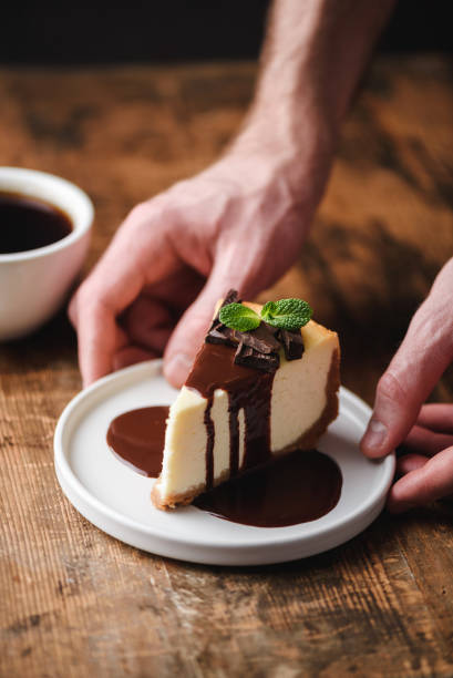 istock Cheesecake with chocolate sauce and cup of coffee 1125423947
