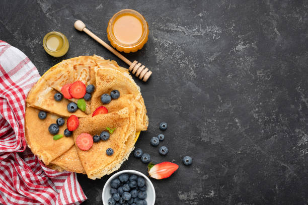 istock Crepes or blini with fresh berries and honey 1125423951