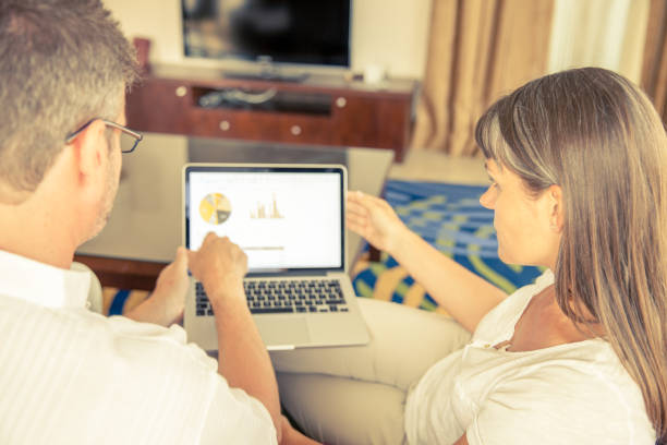 istock Man and woman on a couch with laptop 1125425746