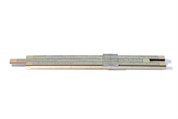 Old slide rule, mechanical calculator is isolated on white background. Vintage logarithmic ruler