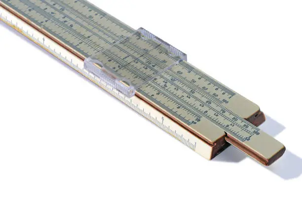 Old slide rule, mechanical calculator is isolated on white background. Vintage logarithmic ruler