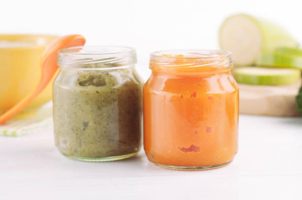 Broccoli and pumpkin vegetable puree in jars Broccoli and pumpkin vegetable puree in jars on white wooden background near ingredients baby food stock pictures, royalty-free photos & images