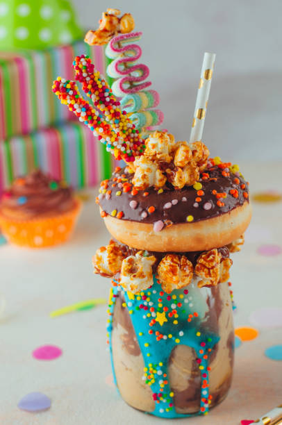 istock Freak shake topping with chocolate donut and sweets on the party table 1125439031
