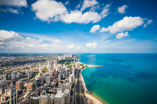 High angle view of skyscrapers in Chicago and Lake Michigan on a sunny day.