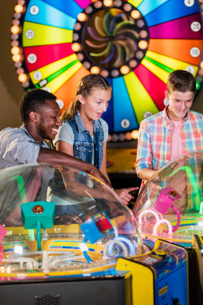 istock Multi-ethnic teenage friends playing arcade games 1125439875