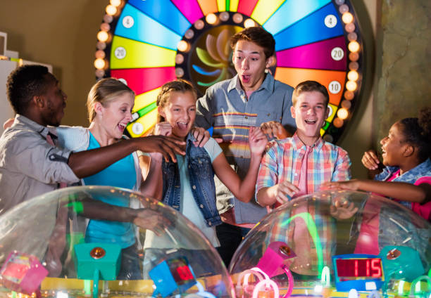 istock Multi-ethnic teenage friends playing arcade games 1125439878