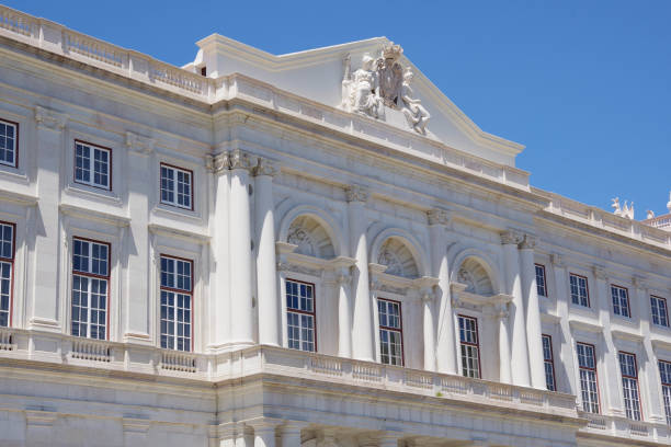 Lisbon, Portugal - July 21, 2018: The gleaming exterior of the Palace of Ajuda pierces a perfect blue sky.  The palace was built to house the Portuguese royal family after the 1755 earthquake destroyed much of Lisbon, inclusing the royal residence.  It has been a national monument since 1910 and several rooms have been open to visitors to see since 1968.