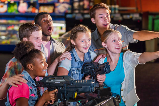 istock Multi-ethnic teenage friends playing arcade games 1125442880