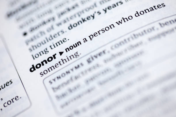 istock Close up to the dictionary definition of word Donor 1125443473