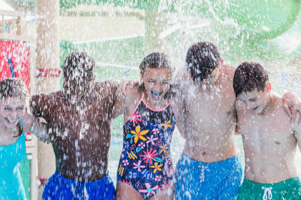 istock Multi-ethnic teenagers at water park getting drenched 1125445277