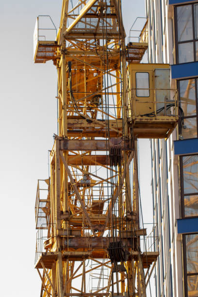 istock Construction cranes and high-rise building under construction against blue sky. 1125447548