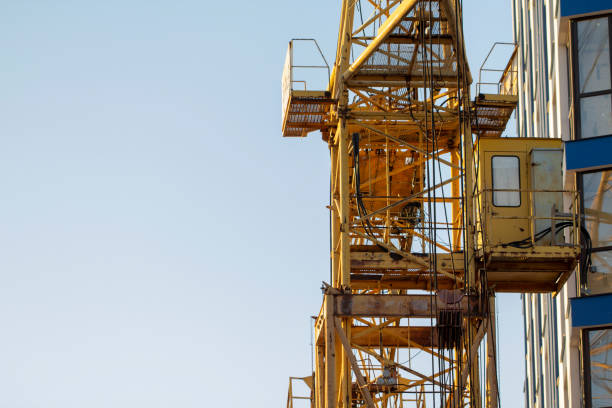 istock Construction cranes and high-rise building under construction against blue sky. 1125447551