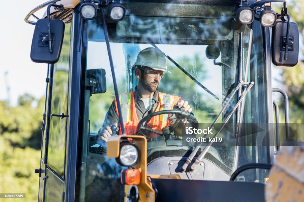 Man Using Backhoe Construction Worker Operating A Backhoe Stock Photo - Download Image ...