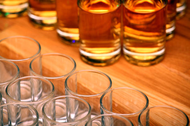 istock empty glass shot whiskey wooden table 1125449142