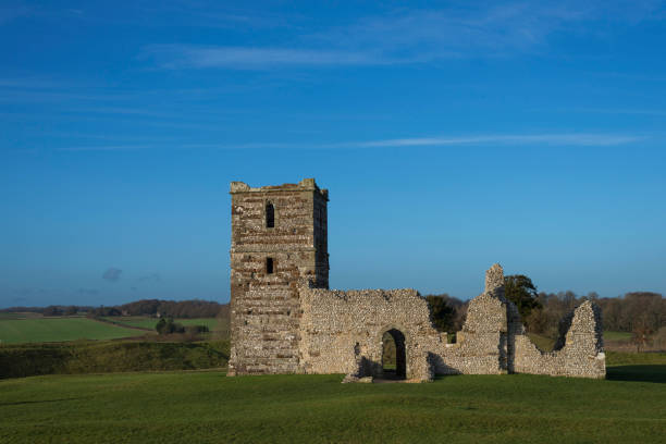 istock 12th Century Church and Earthworks, England 1125449145