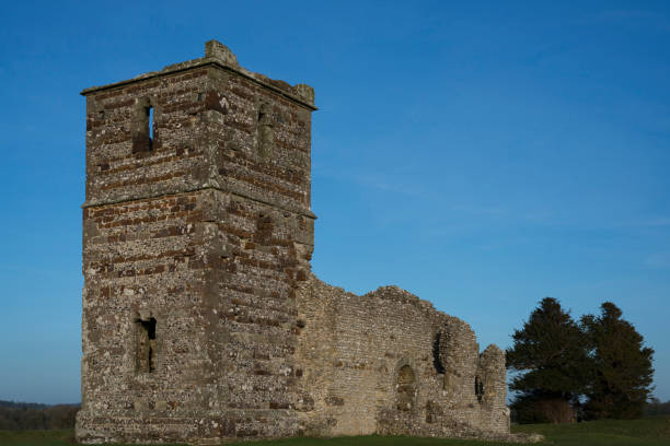 istock 12th Century Church and Earthworks, England 1125449320