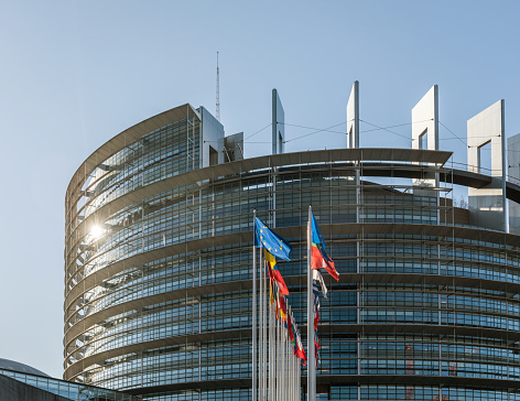 Strasbourg, France - June 6, 2018: Horizontal image all European Union members states flags in front of European Parliament building on a clear blue sky day before European elections 2019 photograph to illustrate political articles and news