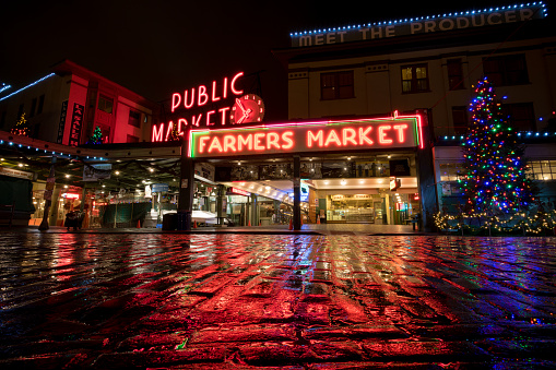 Seattle, USA - December 12, 2018: Pike Place Market illuminated with Christmas lights early in the night just after it rained.