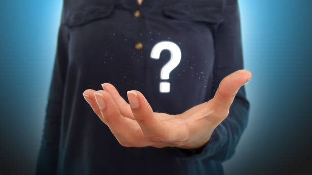 istock Businesswoman on blurred background holding hand interrogation point 1125453688